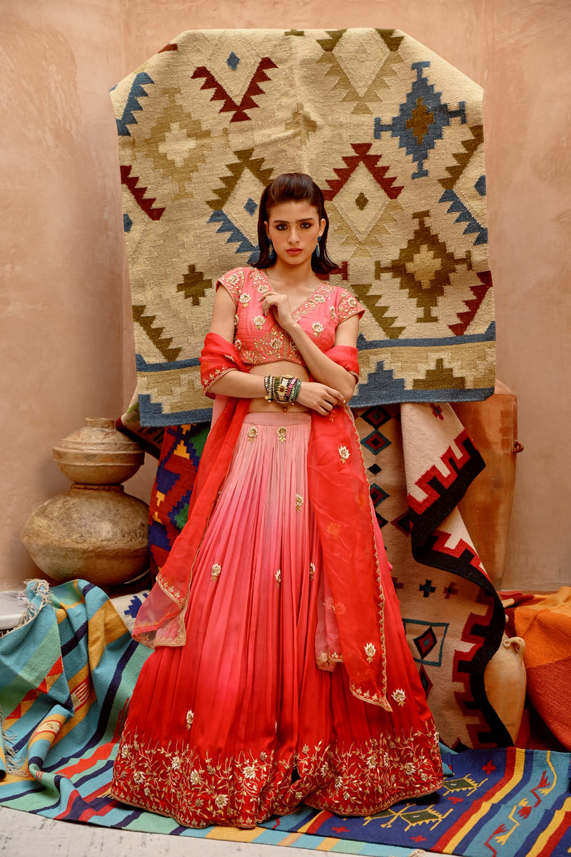 Red and coral ombre ruched lehenga with blouse and dupatta