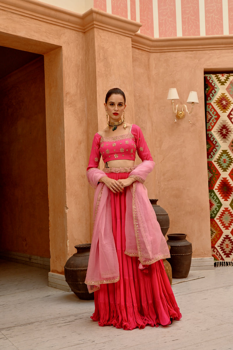 Hot pink tier lehenga with blouse and  dupatta.